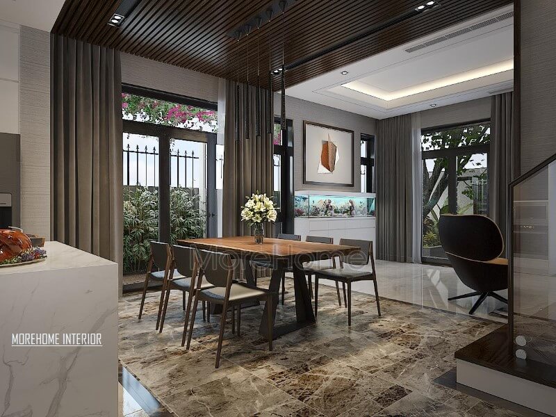 Bố trí phòng ăn hiện đại thông thoáng, chan hòa với thiên nhiên từ hệ cửa lớn giúp ánh sáng lan tỏa tối đa nhưng vẫn chắn nắng kịp thời từ rèm 2 lớp. Thiết kế phòng ăn biệt thự