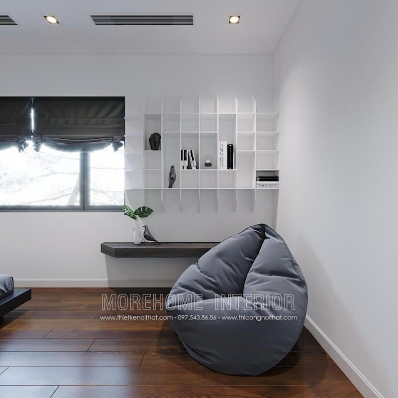 Kệ trang trí sơn trắng kết hợp cùng bàn gỗ óc chó ốp tường đơn giản nhưng lại tạo nên vẻ đẹp độc đáo, mới lạ cho không gian đọc sách trong phòng ngủ.